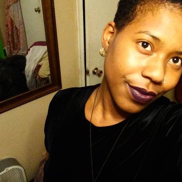 Close-up portrait in warm lighting, gentle expression, mirror in background