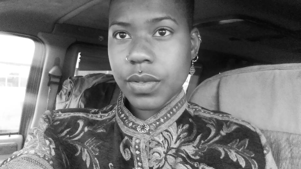 Portrait in motion, adorned in patterned fabric, gaze steady and whole